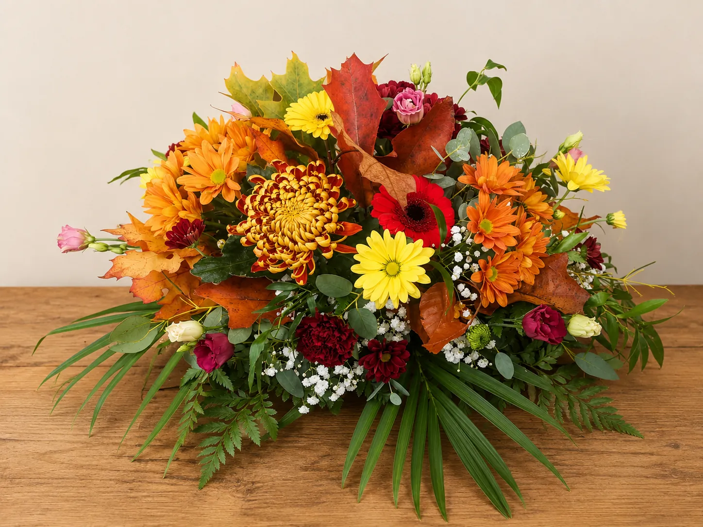 Autumn-toned funeral tribute with orange chrysanthemums and red gerbera
