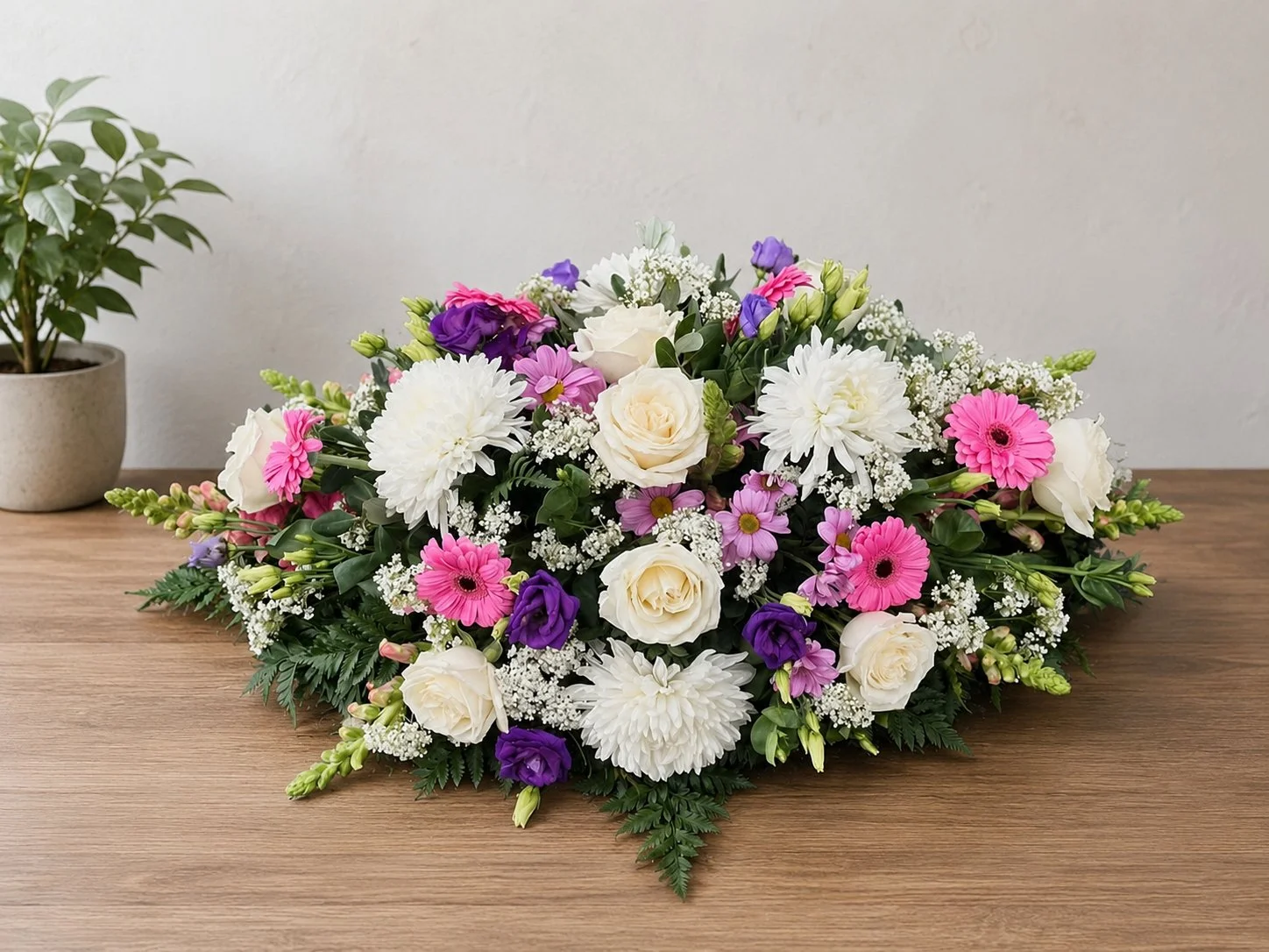 Mixed colour funeral posy with pink roses, gerberas and chrysanthemums by Quality Plants and Flowers
