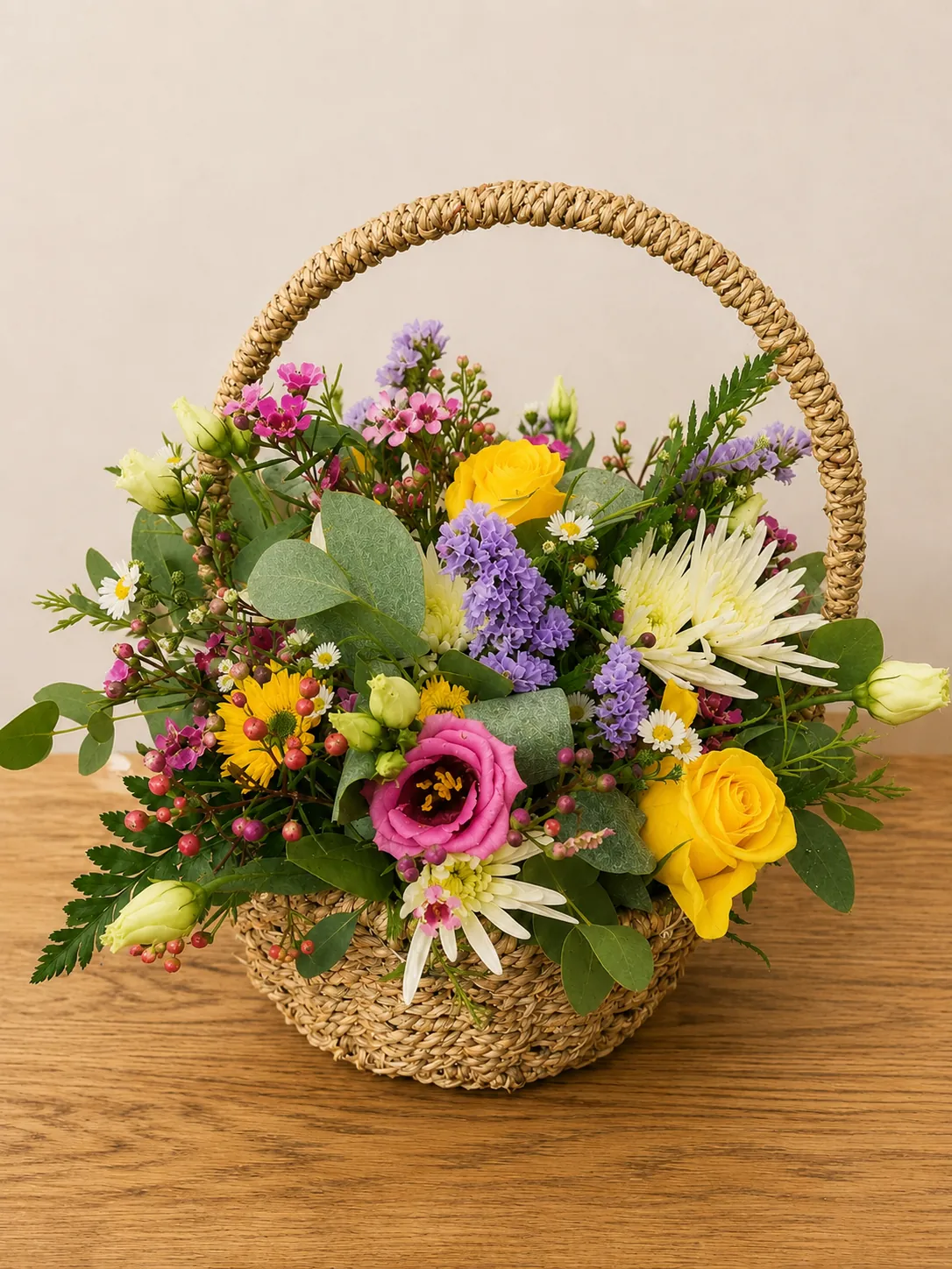 Wicker basket flower arrangement with yellow roses and white chrysanthemums