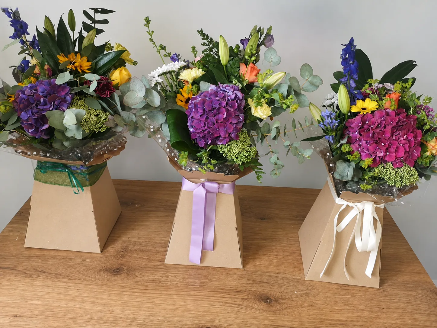 Three box arrangement gifts side by side showing purple, lilac and magenta hydrangea colour palettes