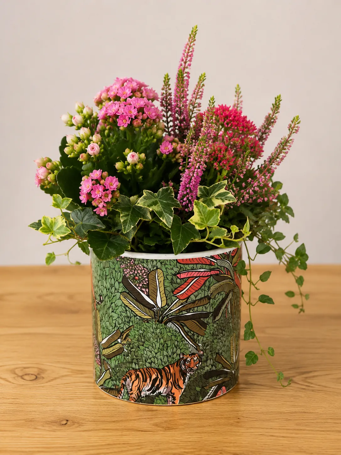 Kalanchoe, heather and variegated ivy planter in a tiger and jungle-print ceramic pot