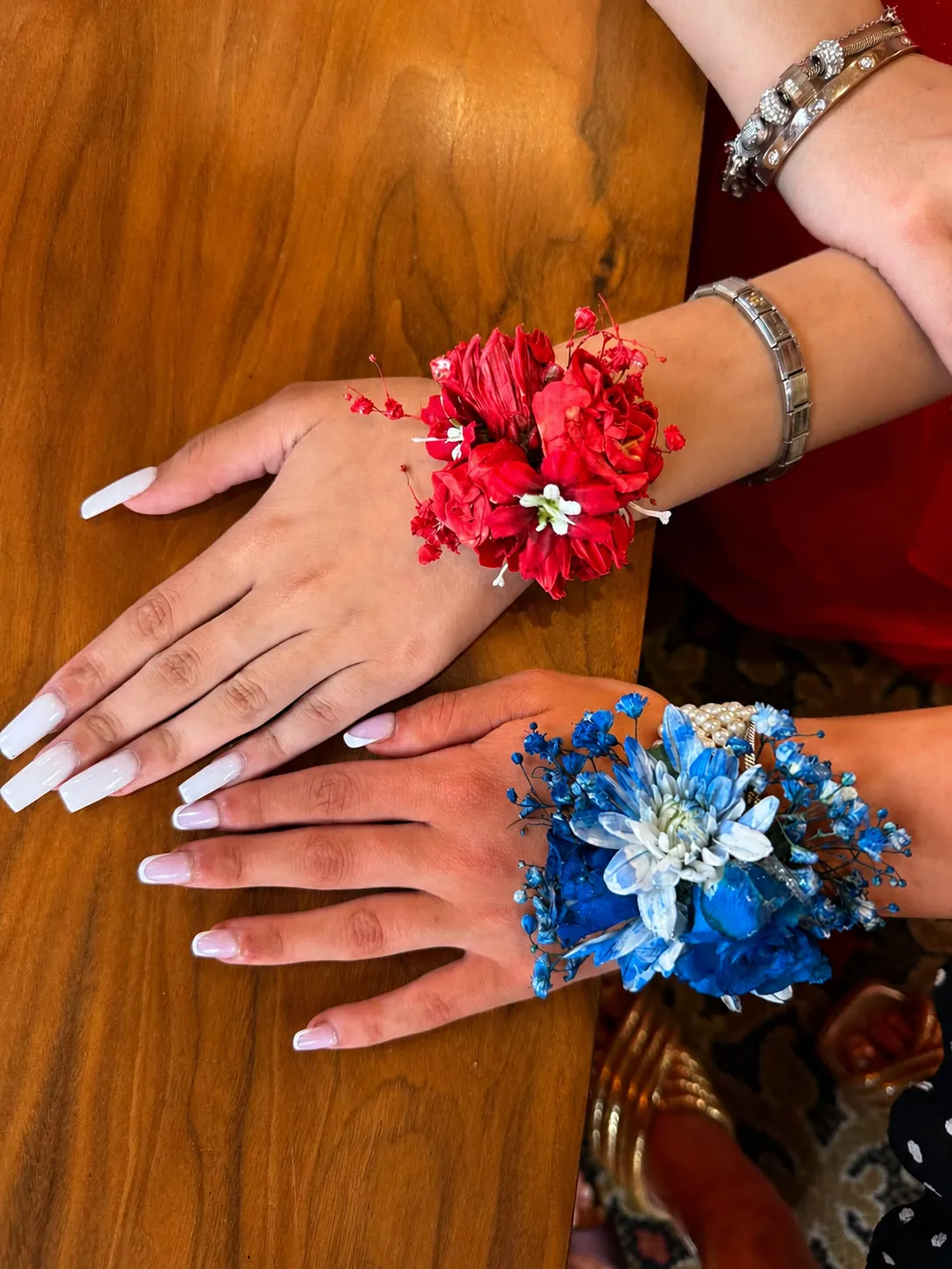 Red and blue flower wrist corsages worn for a prom night