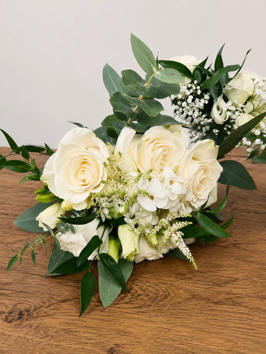 Ivory rose and stephanotis wedding table arrangement