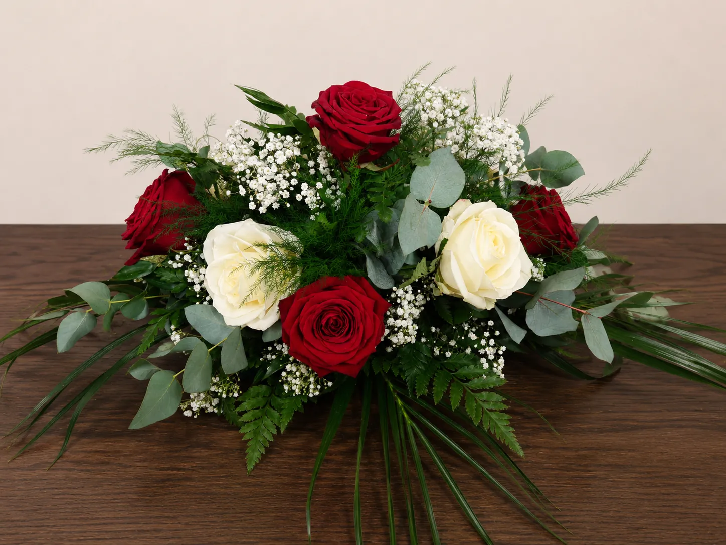 Red and white rose wedding centrepiece with eucalyptus foliage