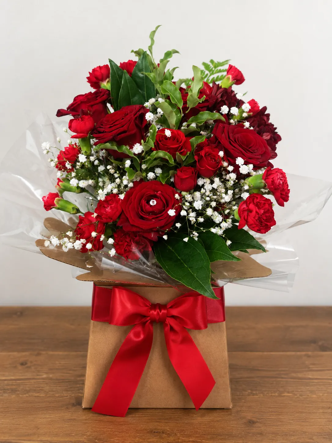 Red rose bouquet gift box with a red ribbon bow