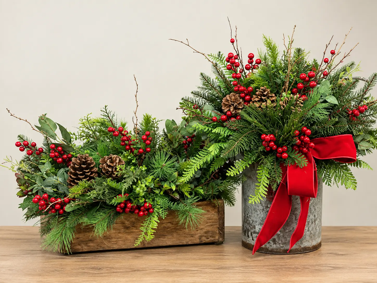 Pair of Christmas trough and pail arrangements with red and green foliage